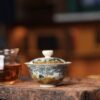 A11FE551-D0FC-4BCF-8CBC-699AFB49A7EB_4_5005_c Hand-painted Underglaze Golden Qinghua Ceramic Landscape 150ml Gaiwan